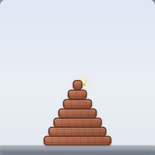 Stack gameplay: a tall pyramid of blocks stacked up to a glowing goal star